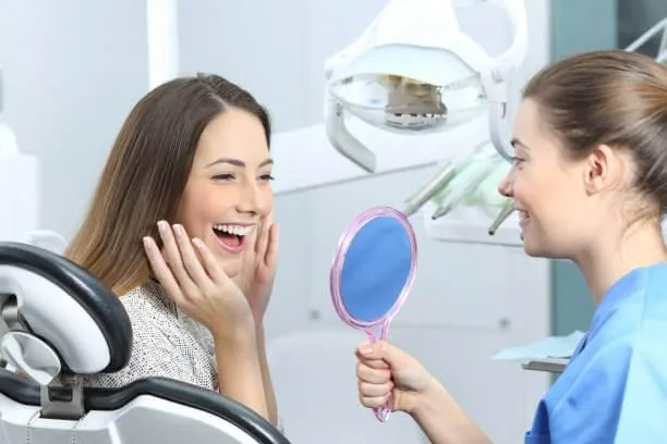 happy patient smiling confidently after receiving temporary veneers