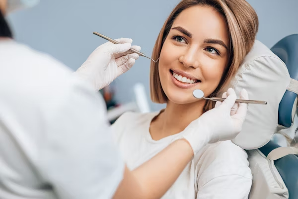 a woman smiling at her dentist