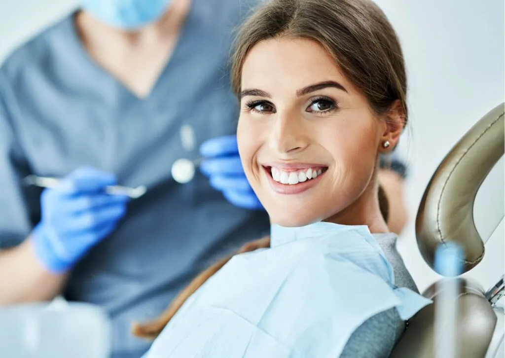 Smiling patient after a cosmetic dental consultation about tooth bonding to repair chipped, cracked, or discolored teeth.